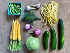 Colorful selection of certified organic vegetables in a mid-season CSA box.